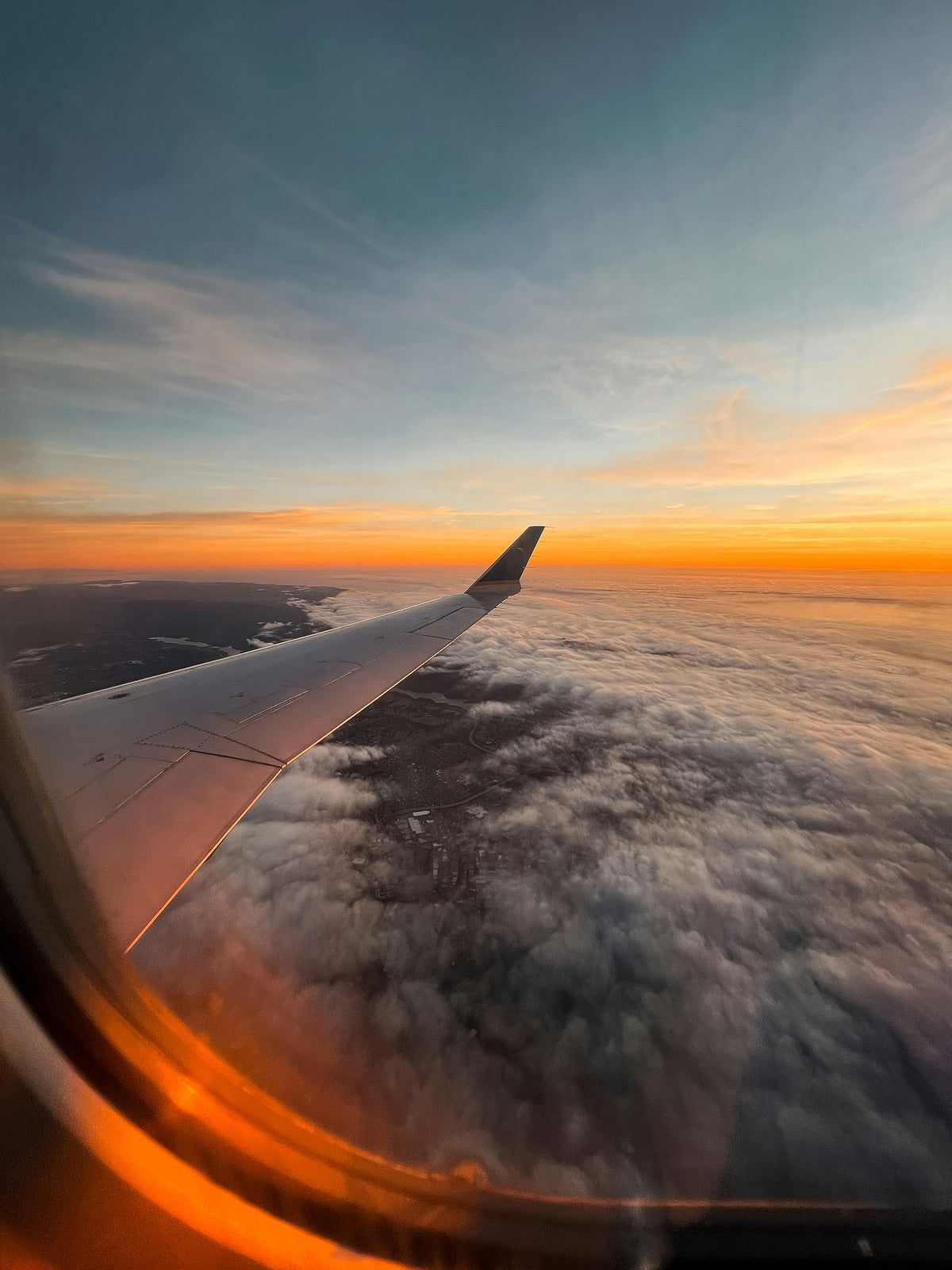 A plane wing at sunset seen from the window